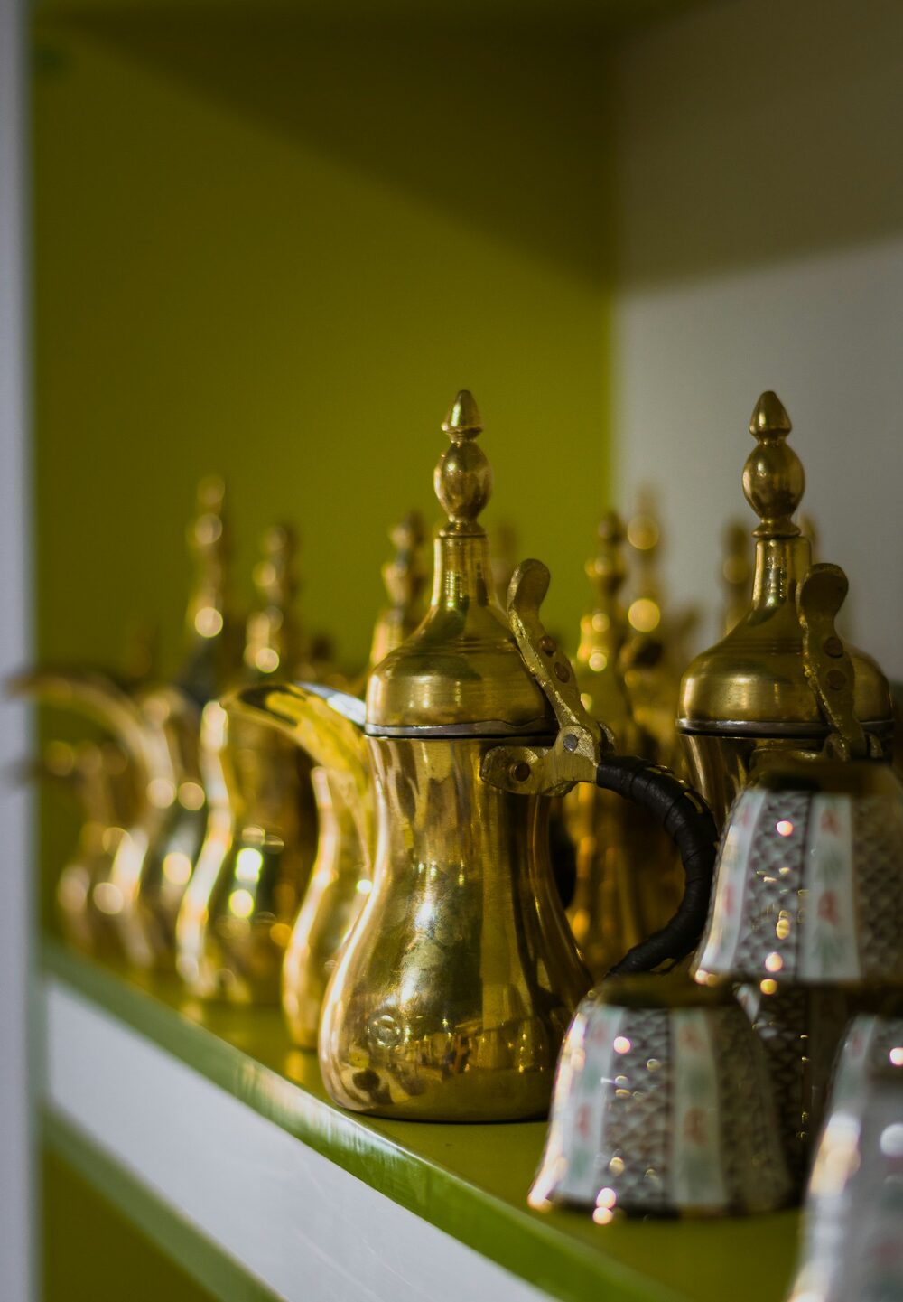 Brass coffee pots on a shelf