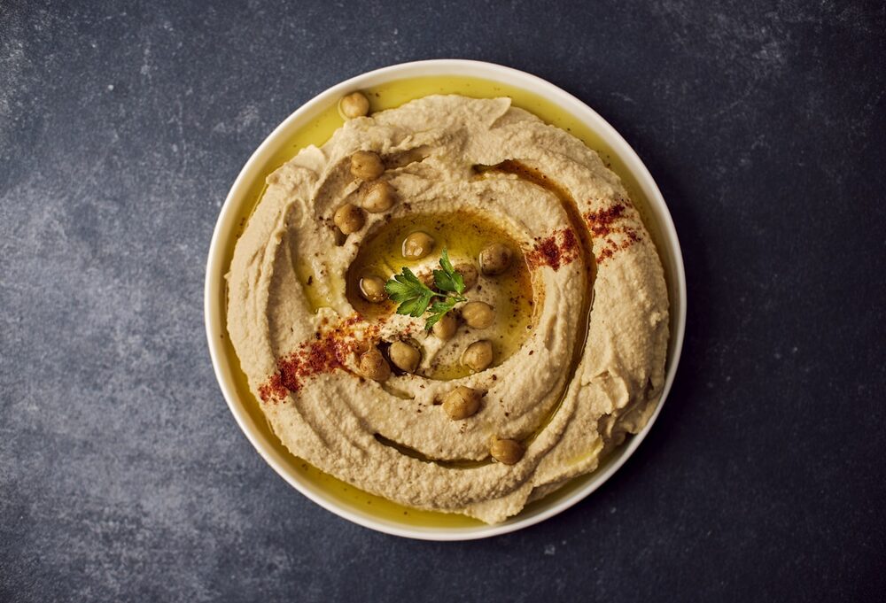 A plate of hummus with olive oil