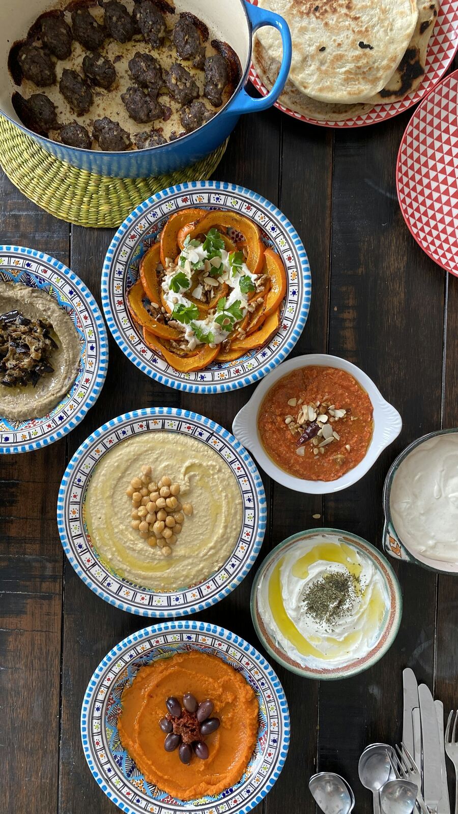 A spread of Damascene mezze on a dark table, seen from above